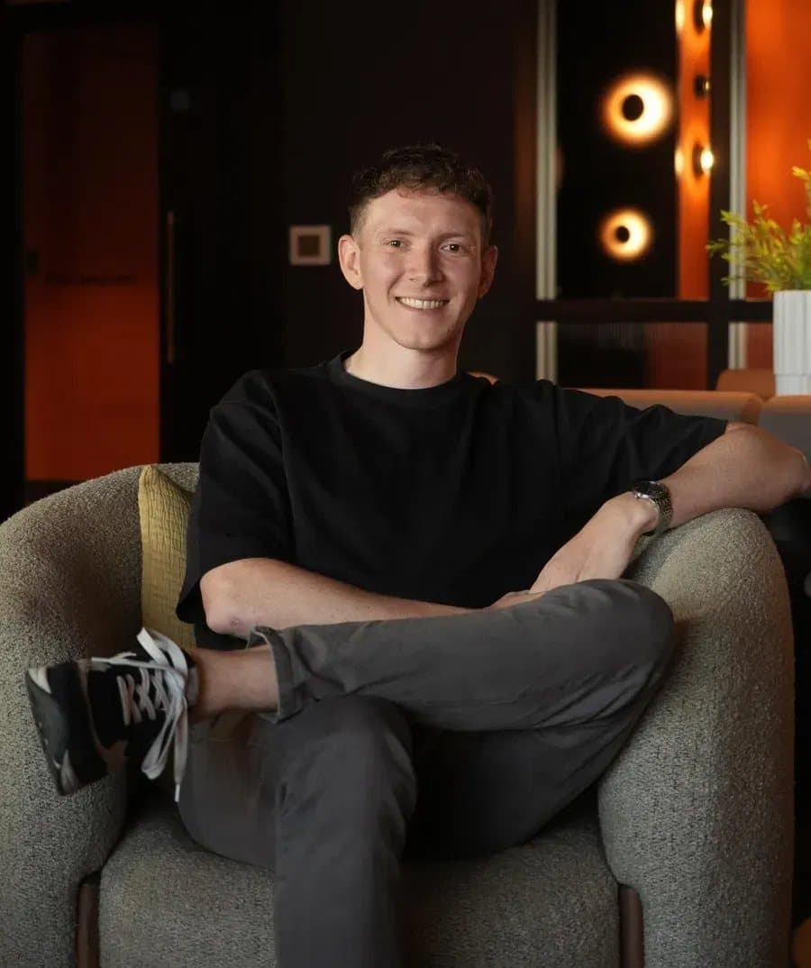 Sam from Ascenso Accounting, sitting in an armchair and smiling
